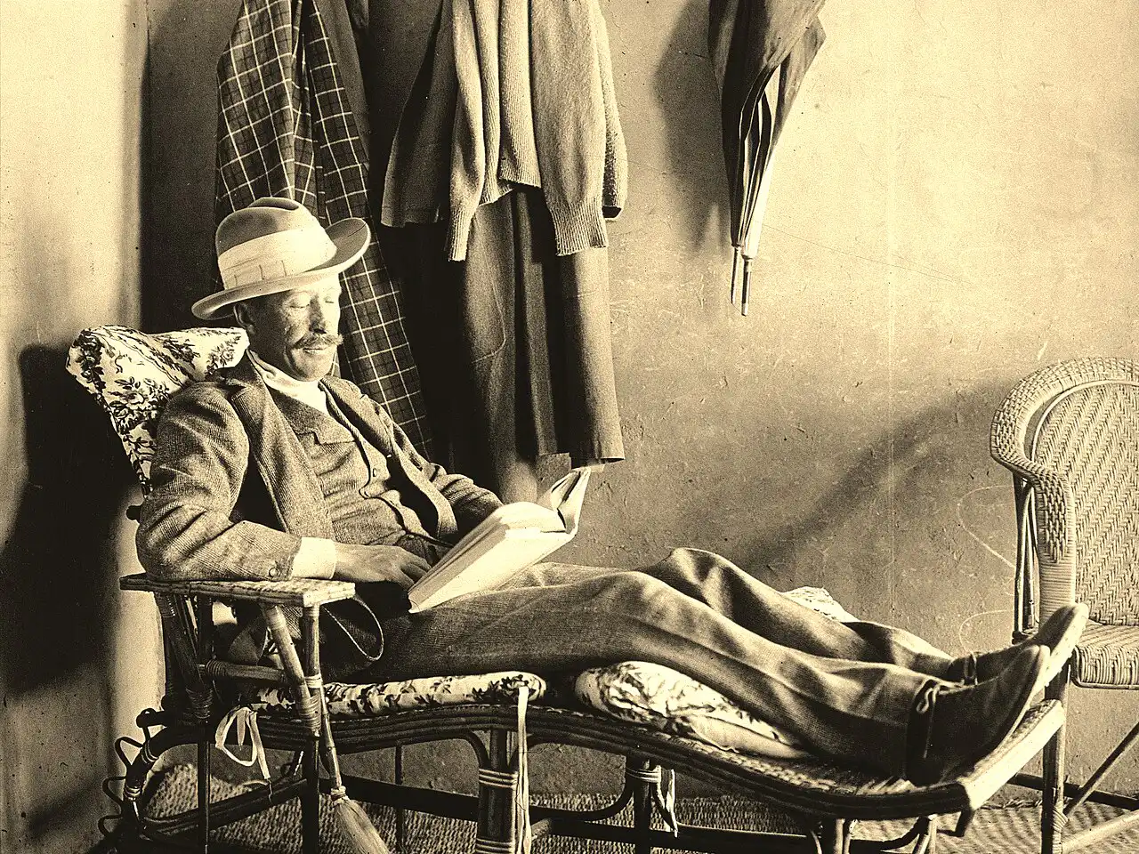 Lord Carnarvon, the wealthy backer of the Tutankhamun excavation, reading in a garden