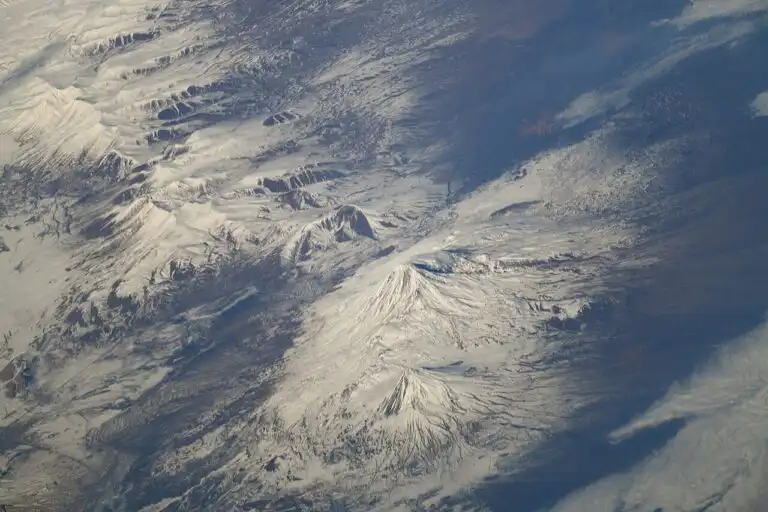 An oblique view of Mount Ararat in eastern Turkey, its twin snowy peaks rising above the surrounding terrain, photographed from the International Space Station